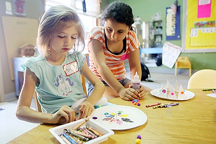 Avery Mueller, front, works on crafts with Emma Fichter during a vacation bible school held Wednesday at the Special Learning Center in Jefferson City. St. John's Lutheran Church in Schubert held the classes.