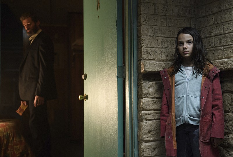 This image released by Twentieth Century Fox shows Dafne Keen, right, and Hugh Jackman in a scene from "Logan."  