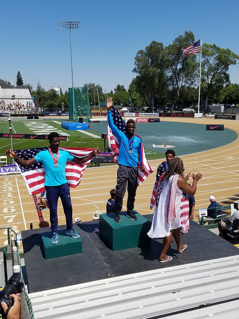 Jarrion Lawson receives his gold medal at the USATF Outdoor Championship in Sacremento, Cal.