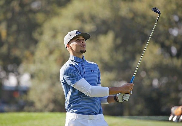 In this Oct. 12, 2016, file photo, Warriors guard Stephen Curry follows his shot during the pro-am event of the Safeway Open PGA in Napa, Calif.