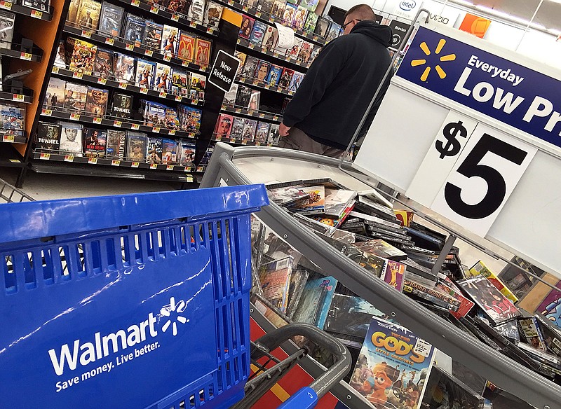 In this June 5, 2017, photo, a shopper looks at merchandise at Walmart in Salem, N.H. Hundreds of inventors are auditioning their wares for Walmart, hopeful the world's largest retailer will consider their products the next big thing and stock them on shelves in nearly 4,700 brick-and-mortar stores. They've already been promised spots on the company's online portals as it battles Amazon for billions of dollars in revenue. 