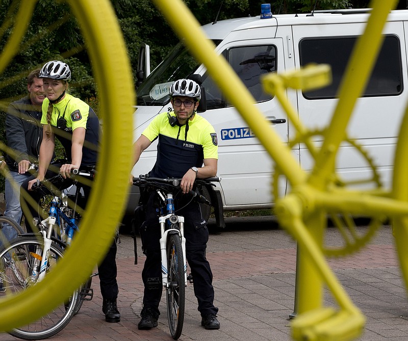 German police officers patrol near Burgplatz square prior to the team presentation of the Tour de France cycling race in the center of Duesseldorf, Germany, Thursday, June 29, 2017. (AP Photo/Peter Dejong)