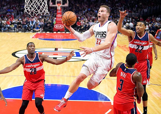 Blake Griffin of the Clippers drives to the basket as Wizards teammates (from left) Ian Mahinmi, Bradley Beal and Otto Porter Jr. defend during a game game last season in Los Angeles.
