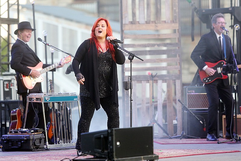 Wynonna Judd, center, sings Saturday during Salute to America's "Inside the Walls" summer concert at the Missouri State Penitentiary. The concert kicked off Fourth of July celebrations in Jefferson City and is the second time a concert has been held inside the former prison.