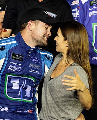 Ricky Stenhouse Jr. leans in for a kiss from girlfriend Danica Patrick in Victory Lane after he won Saturday night's NASCAR Cup Series race at Daytona International Speedway in Daytona Beach, Fla.