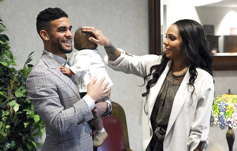 In this photo provided by Sporting Kansas City and taken March 16, 2017, from left to right, Dom Dwyer, infant son Cassius and wife Sydney Leroux gather for Dwyer's naturalization ceremony at Charles Evans Whittaker Courthouse in Kansas City, Mo. Dwyer and Leroux are the first husband and wife duo to each score for the U.S. national soccer team. (Olivia Brestal/Sporting Kansas City via AP)