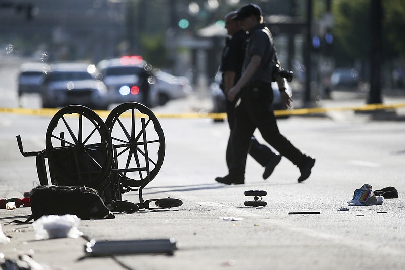 A wheelchair, shoes and other items lay in the street at the scene of an accident at the intersection of 200 South and 400 West Streets in Salt Lake City on Tuesday, July 4, 2017. Police say a car drove onto the sidewalk. (Spenser Heaps/The Deseret News via AP)