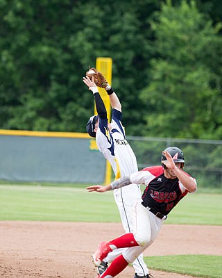 Renegades shortstop Jordan Smith hauls in a pop up while trying to avoid a Cassville baserunner during Tuesday afternoon's game at Vivion Field.