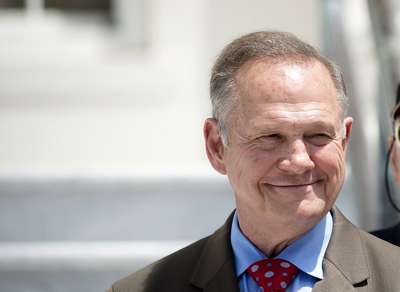 FILE -In this April 26, 2017 file photo, Roy Moore smiles before announcing his Alabama Junior Senate race candidacy, in Montgomery, Ala. As former Alabama Chief Justice Roy Moore, runs for U.S. Senate, he doesn't shrink from telling voters he has twice been ousted from the bench for defying federal courts over the Ten Commandments and same-sex marriage. Instead, he wears those rejections as a badge of honor. (Albert Cesare/The Montgomery Advertiser via AP, File)