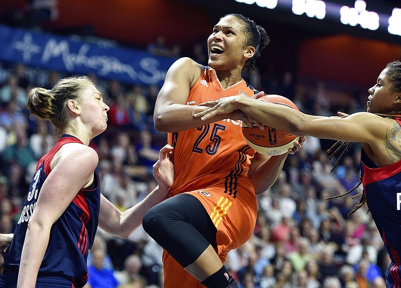 Connecticut Sun's Alyssa Thomas (25) is fouled by Washington Mystics' Tierra Ruffin-Pratt, right, on a drive as Mystics' Emma Meeseman, left, defends in the second half of a WNBA basketball game Saturday, July 8, 2017, in Uncasville, Conn. (Sean D. Elliot/The Day via AP)