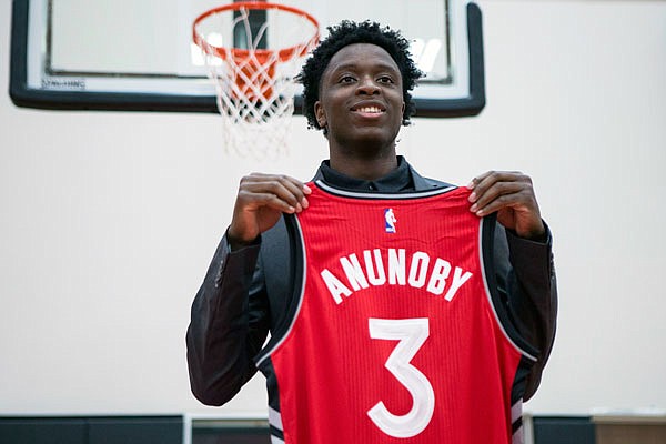 Raptors first round draft pick OG Anunoby holds a jersey as he poses during last month in Toronto. Anunoby, a former Jefferson City Jay, signed with the team Sunday.