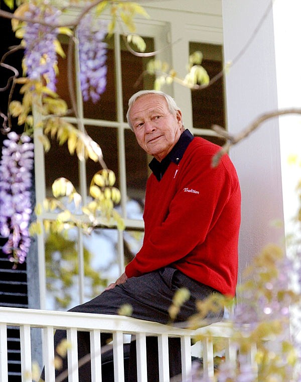 This 2004 file photo shows former Masters champion Arnold Palmer as he sits on clubhouse railing at the Augusta National Golf Club in Augusta, Ga. In his first year as PGA Tour commissioner, Jay Monahan said his top priority was to make Palmer proud. He has seen enough evidence halfway through the year to believe the tour is on the right track.