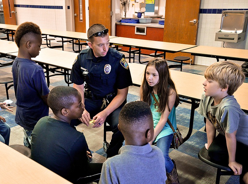 Longview Police Department's Josh Marrs visits with a group of children Tuesday, June 6, 2017, during a summer camp program hosted by School Resource Officers at Parkway Elementary.