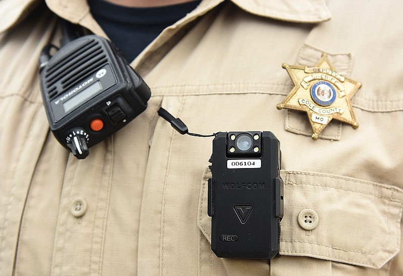 A Cole County sheriff's deputy is shown with his radio microphone and body cam pinned to his chest.