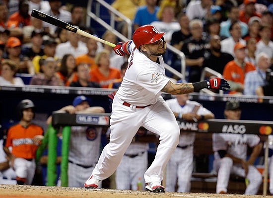 Yadier Molina of the Cardinals hits a solo home run in the sixth inning for the National League in Tuesday night's All-Star Game in Miami.