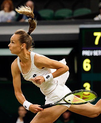 Magdalena Rybarikova serves to Coco Vandeweghe during their women's quarterfinal singles match Tuesday at Wimbledon.