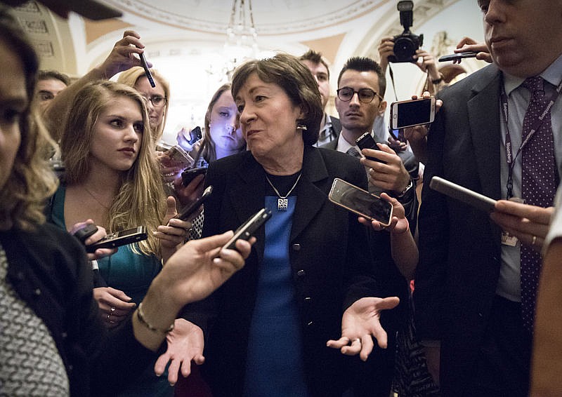 Sen. Susan Collins, R-Maine is surrounded by reporters on Capitol Hill in Washington, Thursday, July 13, 2017, after a revised version of the Republican health care bill was announced by Senate Majority Leader Mitch McConnell of Ky. The bill has faced opposition and challenges within the Republican ranks, including by Sen. Collins.
