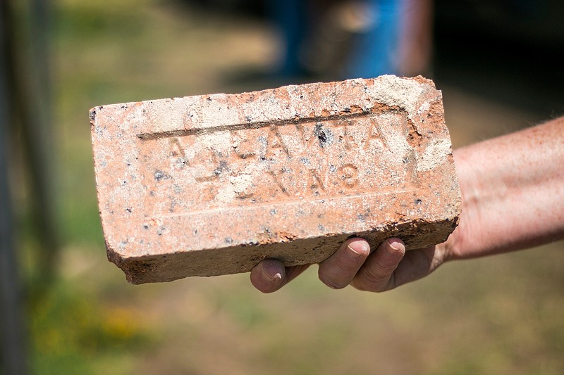 Lisa Greene, a former student of Liberty-Eylau Primary School, holds a brick from the recently demolished school. Greene said materials used to build the school came from the area, such as the brick, which came from Atlanta, Texas. Greene's uncle, Dan Ryan, helped to transport the original materials for construction. Greene plans to use the brick in the construction of a fire pit. Rocks from the school are free for the public to take until Sunday.