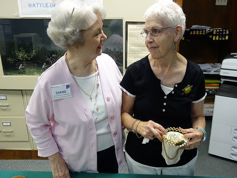 Diane Burre Ludwig, a coordinator for the Kingdom of Callaway Historical Society's July 23 fashion show, talks with contributor Carolyn Rankin about her purse collection. The show, "Fashion and Fun: A Century of Accessories," will be 2-4 p.m. at Court Street United Methodist Church in Fulton.