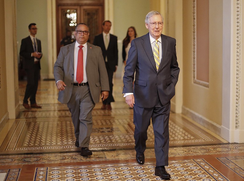 FILE - In this July 13, 2017 file photo, Senate Majority Leader Mitch McConnell of Ky. walks to his office on Capitol Hill in Washington. Republicans’ latest health care plan would create winners and losers among Americans up and down the income ladder, and across age groups. (AP Photo/Pablo Martinez Monsivais, File)