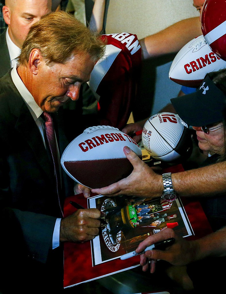 Alabama NCAA college football coach Nick Saban signs an autograph for fans during the Southeastern Conference's annual media gathering, Wednesday, July 12, 2017, in Hoover, Ala.