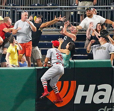 Cardinals left fielder Tommy Pham watches as fans bobble a ball hit by  Josh Bell of the Pirates for a three-run home run in the bottom of the ninth inning Friday night in Pittsburgh.