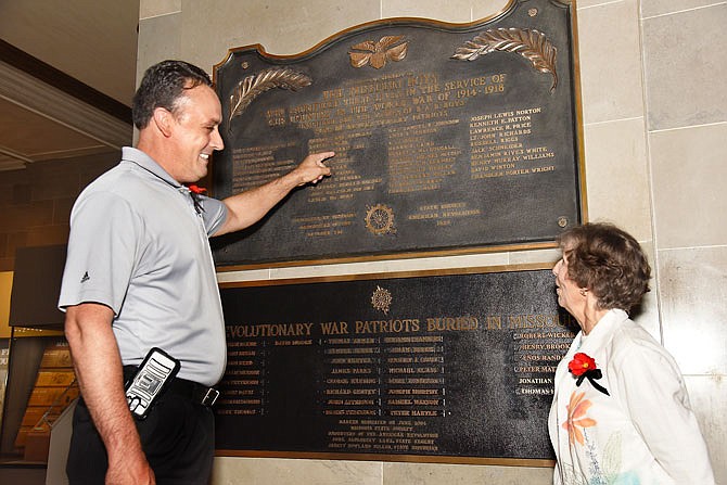 JULY 2017 FILE: Jeremy Amick points to a name on the plaque Friday while talking with Marilyn Gross in the Capitol. The Missouri State Society of the Daughters of the American Revolution hosted a World War I plaque rededication ceremony in the Capitol Rotunda before moving to the history wing of the museum to unveil it.