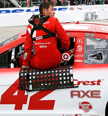 Kyle Larson climbs out of his car after qualifying Friday at the New Hampshire Motor Speedway in Loudon, N.H.