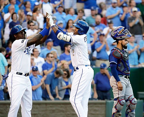 Alcides Escobar (right) celebrates with Royals teammate Jorge Soler after hitting a two-run home run during the second inning of Friday night's game against the Rangers at Kauffman Stadium.