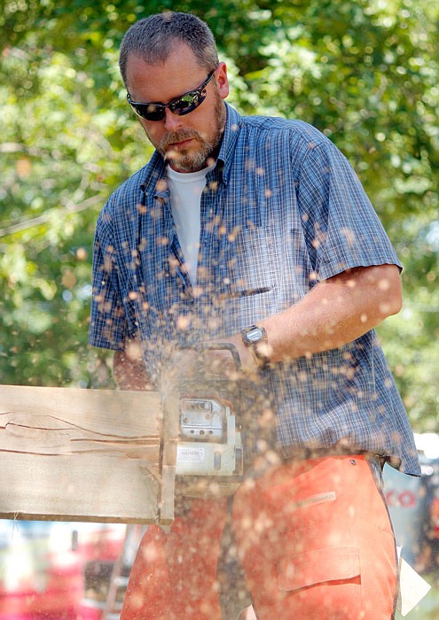 Matt Hale saws through a piece of wood Saturday, July 15, 2017 during the chainsaw contest at the Osage County Fair in Linn. Participants were timed to see how fast they could cut through the wood sawing in an upward and downward direction. In the opening round, Hale used a inch Stihl saw and got a time of 15.3.