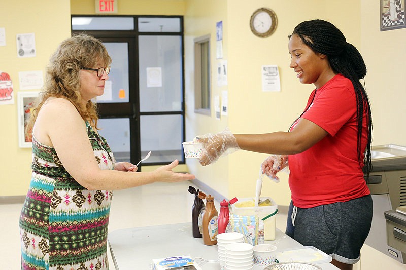 Fran Roark, left, is served ice cream by Kiana Owens on Saturday, July 15, 2017 at the Salvation Army Community Center in Jefferson City. Owens attends Lincoln University and also Quinn Chapel AME Church, which hosted the meal for patrons of the community center.