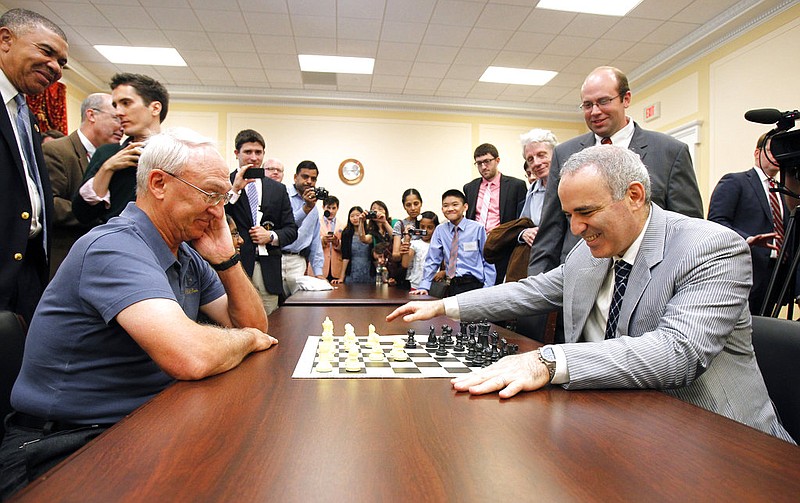 In this June 18, 2014, photo, World Chess Champion Garry Kasparov, right, and Rex Sinquefield, founder and president of the Board of Directors of the St. Louis Chess Club, kick-off the first-ever Congressional Chess Match at the Rayburn House Office Building in Washington. 