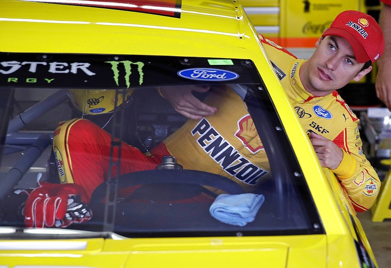 Driver Joey Logano climbs into his car as he prepares for a practice session for Sunday's NASCAR Cup Series 301 auto race at the New Hampshire Motor Speedway in Loudon, N.H., Saturday, July 15, 2017. 