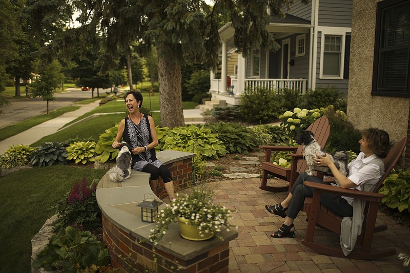 Bobbi Deeney, left, and Beth Gunderson with their dogs, Oliver and Nelson, on the patio in front of Deeney's house on June 28, 2017 in the Minikahda Vista neighborhood of St. Louis Park, Minn. 