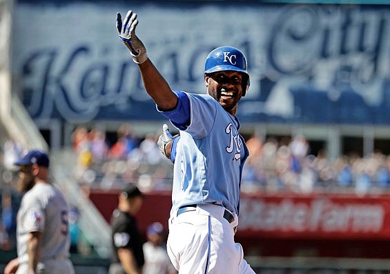Lorenzo Cain of the Royals signals to his teammates after hitting an RBI single in the bottom of the ninth inning of Sunday's game against the Rangers at Kauffman Stadium.
