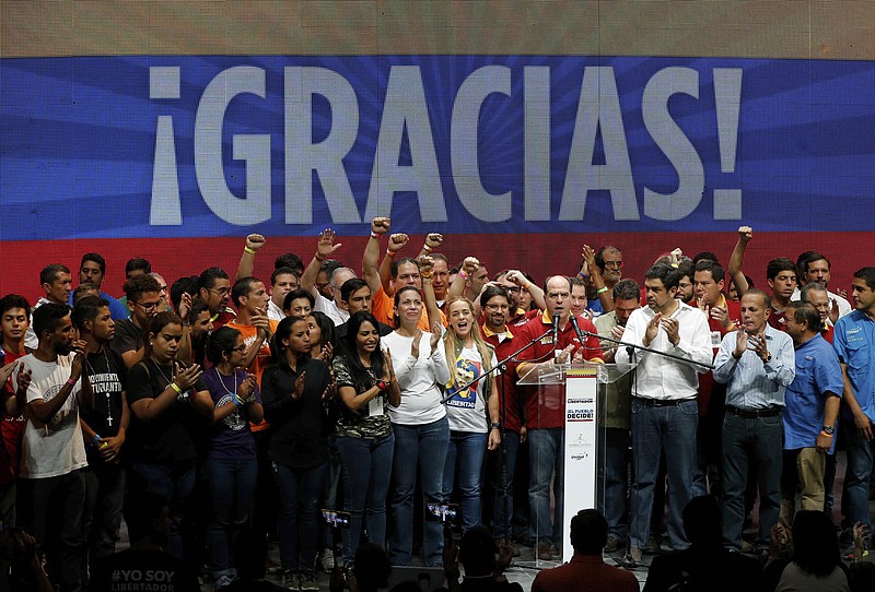 Opposition leaders celebrate after the announcement of results of a symbolic referendum in Caracas, Venezuela, Sunday, July 16, 2017. Venezuelan's opposition said more than 7.1 million people responded to its call to vote Sunday in a symbolic rejection of President Nicolas Maduro's plan to rewrite the constitution, a proposal that has raised tensions in a nation suffering through widespread shortages and months of anti-government protests. (AP Photo/Ariana Cubillos)