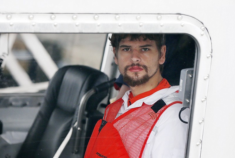 FILE - This Sept. 27, 2016 file photo shows Nathan Carman arriving in a small boat at the US Coast Guard station in Boston. Carman's family filed a lawsuit in New Hampshire on Monday, July 17, 2017 accusing him of killing his grandfather and possibly his mother, who was lost at sea during a mother-son fishing trip. The family says Carman wanted to collect a multimillion-dollar inheritance. (AP Photo/Michael Dwyer)