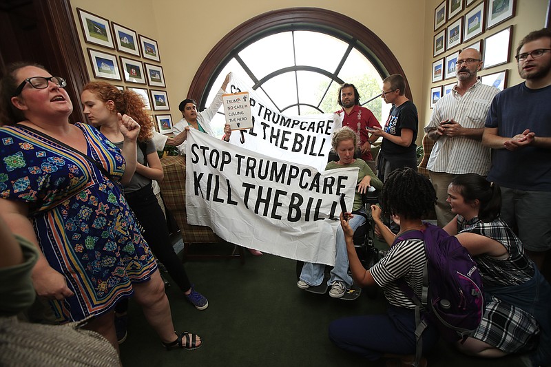 Protesters agains the Republican health care bill gather inside the office of Sen. Rob Portman, R-Ohio, on Capitol Hill in Washington, Monday, July 17, 2017. (AP Photo/Manuel Balce Ceneta)
