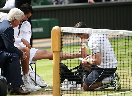 Marin Cilic receives treatment on his foot during a medical timeout during Sunday's men's singles final against Roger Federer at Wimbledon.