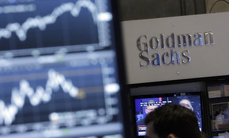 FILE - In this Oct. 16, 2014, file photo, a screen at a trading post on the floor of the New York Stock Exchange is juxtaposed with the Goldman Sachs booth. Goldman Sachs, the most Wall Street of Wall Street firms, is pushing quietly into the realm of consumer banking. (AP Photo/Richard Drew, File)