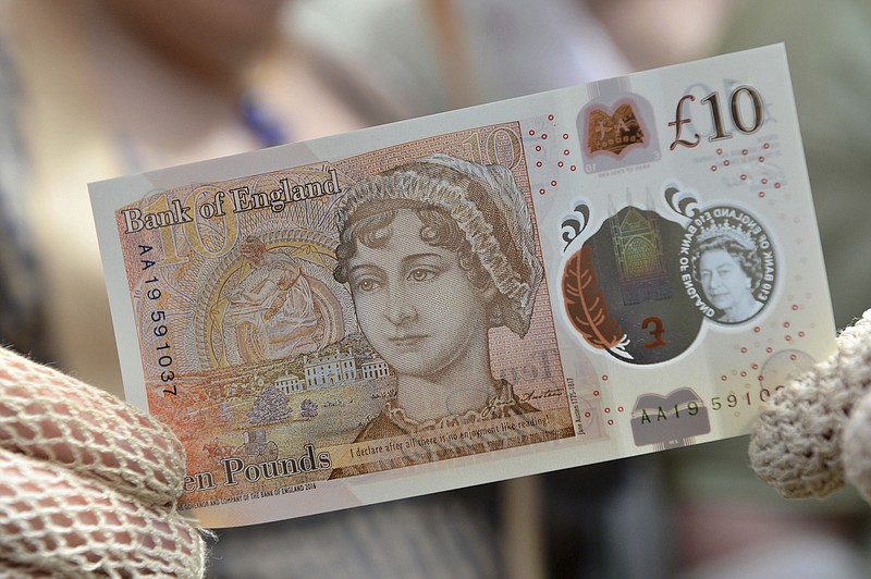 <p>AP</p><p>People in period costume display the new £10 note featuring Jane Austen, which marks the 200th anniversary of Austen’s death, during the unveiling at Winchester Cathedral.</p>