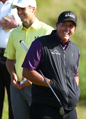 Phil Mickelson and Jordan Spieth smile as they wait to putt on the fourth green during a practice round Tuesday for the British Open at Royal Birkdale in Southport, England.