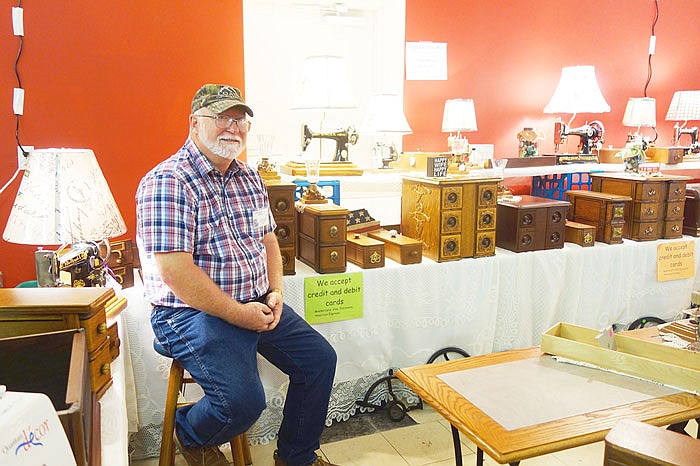 Harold Coats brought repurposed sewing tables to the Rooster Creek Quilt Show. He said his most popular items are the converted drawers, though people also love the sewing machines he turns into lamps.
