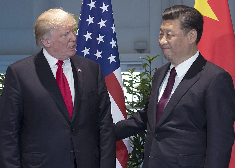 FILE - In this Saturday, July 8, 2017, file photo, U.S. President Donald Trump, left, and Chinese President Xi Jinping arrive for a meeting on the sidelines of the G-20 Summit in Hamburg, Germany. After a cordial meeting between Trump and Xi in April 2017, tensions are simmering again between the world’s two biggest economies. As U.S. and Chinese economic officials prepare to meet Wednesday, July 19, in Washington, the U.S. is weighing whether to slap tariffs on steel imports and risk setting off a trade war, a dicey option to deal with a problem caused largely by China’s massive overproduction of steel. (Saul Loeb/Pool Photo via AP, File)
