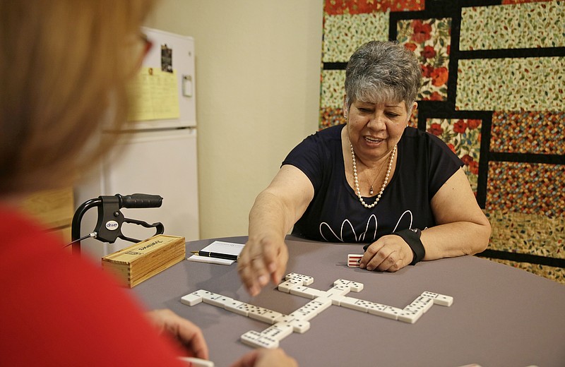 <p>AP</p><p>Cynthia Guzman plays dominoes at her home in Napa, California. Guzman underwent a special kind of PET scan that can detect a hallmark of Alzheimer’s and learned she didn’t have that disease as doctors originally thought, but a different form of dementia. New research suggests those scans may lead to changes in care for people with memory problems that are hard to diagnose.</p>