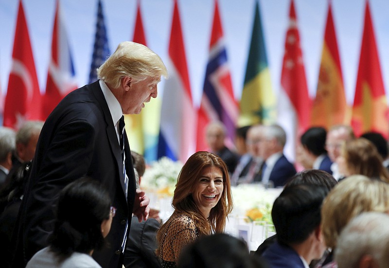 In this July 7, 2017 photo, US President Donald Trump, left, and Juliana Awada, the wife of Argentina's President Mauricio Macri, speak during a dinner in the Kleiner Saal, or "small hall," at the Elbphilharmonie in Hamburg, Germany, during the G-20 summit. (Kay Nietfeld/pool photo via AP)