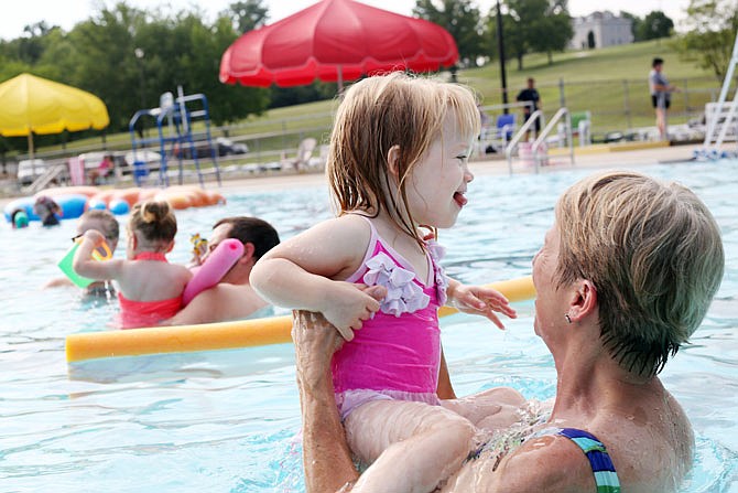 Ellie Lepper, 2, cools off from the heat Tuesday while learning to swim with her grandmother, Robin Grumm, at Ellis-Porter Riverside Pool. The National Weather Service has issued an excessive heat warning for most of Missouri this week with highs expected around 100 degrees and heat indices as high as 115.