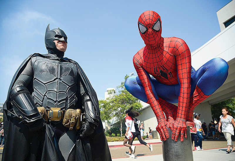 Dorian Black, left, dressed as Batman, and Kyle Blankenfield, dressed as Spider-Man, appear outside during Comic-Con International in San Diego. The annual pop-culture celebration kicked off Wednesday night with a preview of the San Diego Convention Center's showroom floor. Four days of panels, presentations, screenings and autograph signings begin today. 