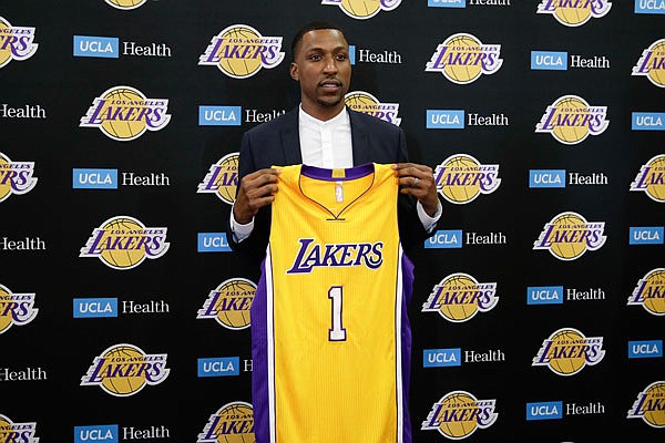Kentavious Caldwell-Pope poses with his Lakers jersey during a news conference Tuesday in Los Angeles.