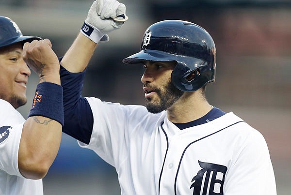 Tigers outfielder J.D. Martinez is congratulated by Miguel Cabrera after they and Justin Upton scored on Martinez's three-run home run during the eighth inning of Saturday's game against the Blue Jays in Detroit.